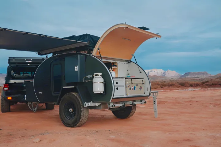 This black teardrop camper trailer with an open outdoor kitchen is ideal for RV rental adventures in the desert.. Escapod Escapod Trailer 2022