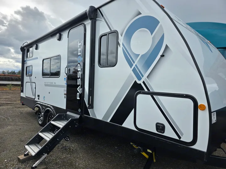 Modern white Keystone Passport SL Series RV with extended steps, perfect for your next rv rental adventure.. Keystone RV Passport SL Ultra Lite 2024