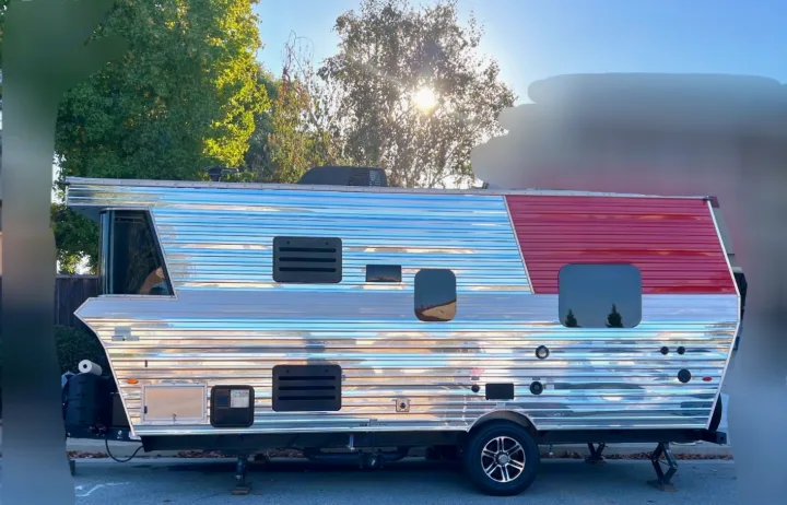 A gleaming, red and silver retro travel trailer, ideal for an rv rental getaway. Perfect for outdoor adventures.. Heartland Terry Classic V21 2018