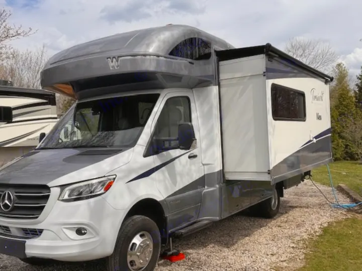 A modern gray and white Class C Winnebago View RV with an extended slide-out, ready for your next rv rental.. Winnebago View 2022