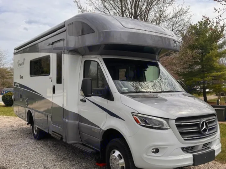 Modern white & gray Mercedes-Benz RV rental parked on gravel. This sleek motorhome is ready for adventures.. Winnebago View 2022