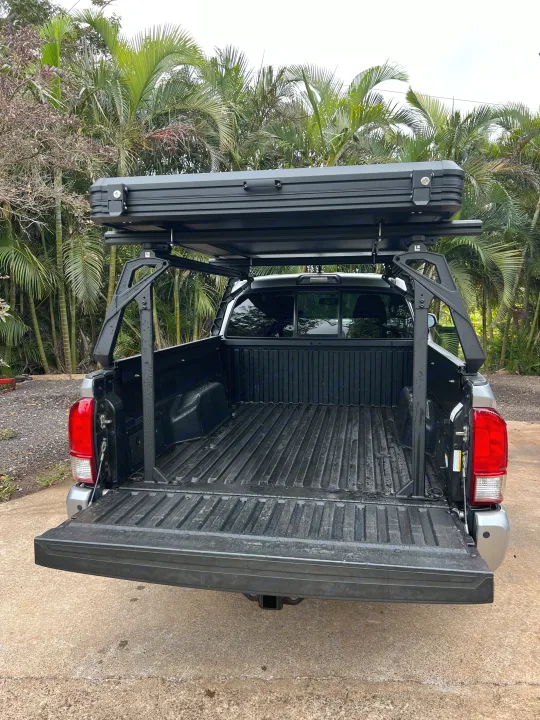 Truck with rooftop tent on bed rack, ideal for an RV rental or overlanding adventure.. Toyota Trailfinder 2016