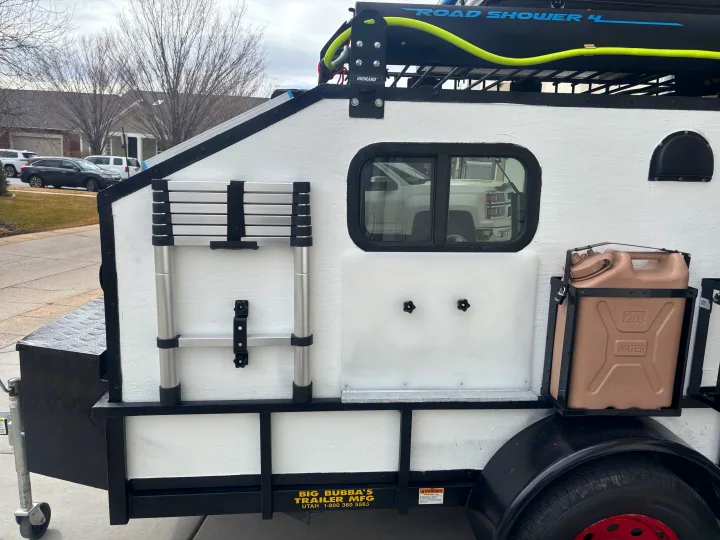 Big Bubba's teardrop trailer, equipped with a Road Shower, water jug, and ladder. Ideal for RV rental adventures.. Overlander HMDE 2025