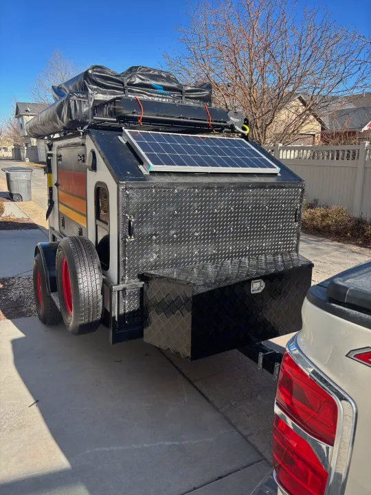 This rugged off-road camper, perfect for an RV rental adventure, features solar power and a Road Shower system.. Overlander HMDE 2025