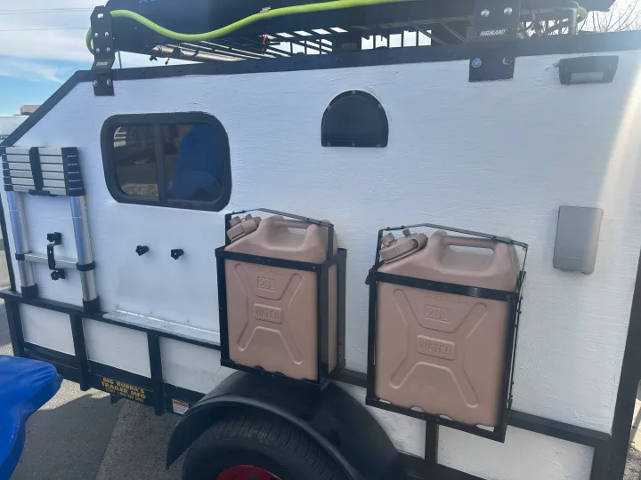 RV rental: Customized trailer with two 20L water cans, a collapsible ladder, and a roof rack system.. Overlander HMDE 2025