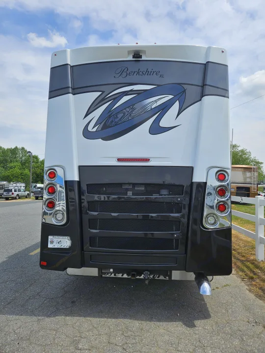 Rear view of a Berkshire XL RV rental motorhome, showcasing its design, taillights, tow hitch, and exhaust.. Berkshire XL 2022