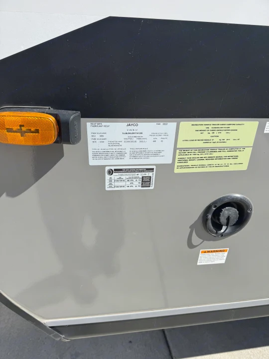 RV rental detailed: Labels show weight, tire specs, VIN, and potable water inlet. Essential safety information for your trip.. Jayco Jay Flight SLX 2022