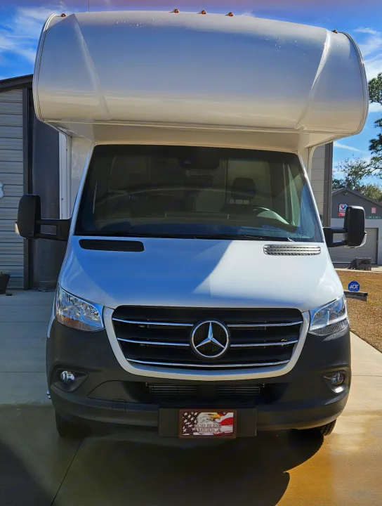 Front view of a sleek white Mercedes-Benz Sprinter RV, ideal for an RV rental adventure on the open road.. Mercedes Coleman 24CL 2024