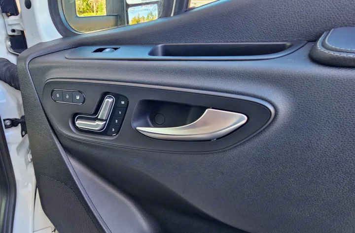 Explore your RV rental: Driver's side door with silver handle, seat memory, and power window controls.. Mercedes Coleman 24CL 2024