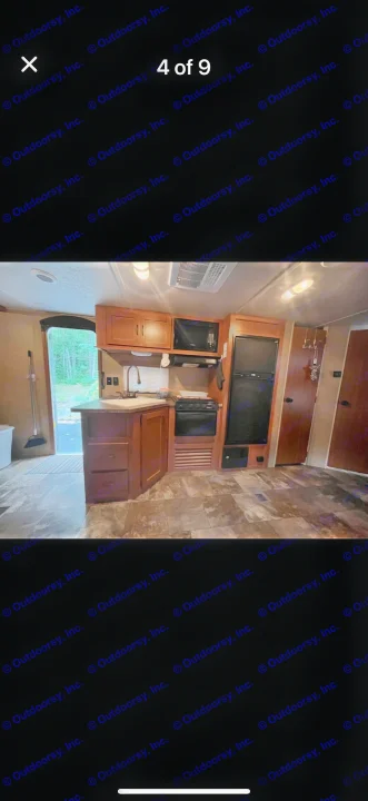 RV rental interior: a functional kitchen area with wood cabinets, sink, stove, microwave, and refrigerator. Perfect for travel!. Forest River Cherokee 2015