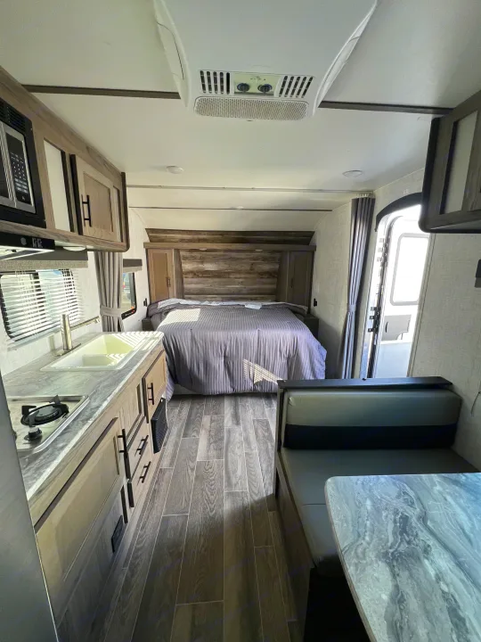Step inside this modern rv rental. It features a full kitchen, comfortable bed, and dinette, all in a stylish grey interior.. Gulf Stream Kingsport 2021