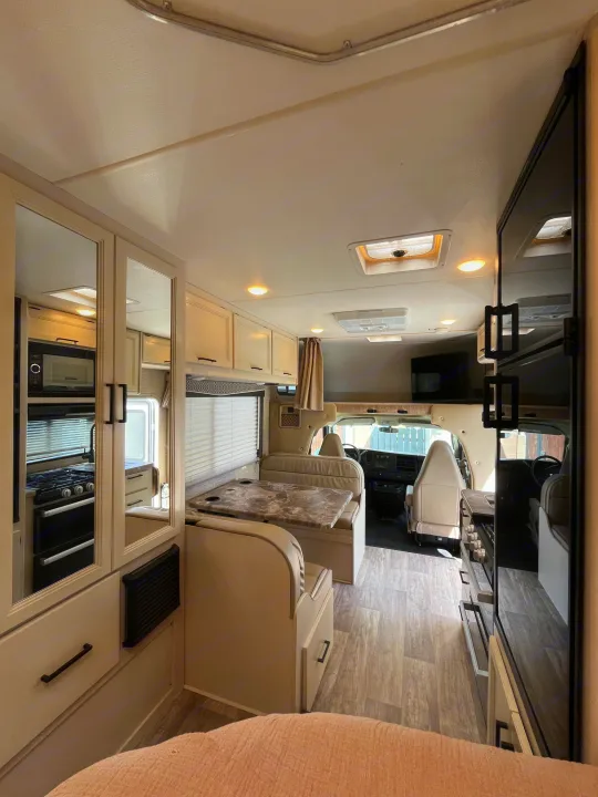 Spacious, clean RV rental interior featuring kitchen, dinette, and cockpit. Perfect for travel adventures!. Thor Chateau 2023