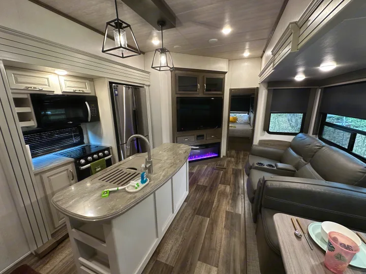 Explore this modern RV rental's inviting kitchen, comfortable living area, and full amenities for your travels.. Keystone RV Cougar 2021