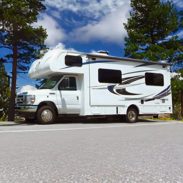 Discover nature! This white RV rental, a Class C motorhome, is parked on a road with trees and a bright blue sky.. Nexus Other 2026