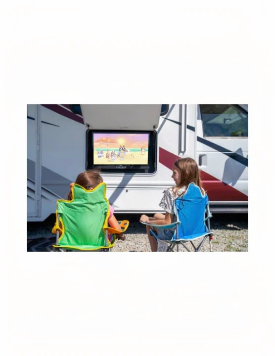 Two girls watch outdoor TV from an RV rental, seated in camping chairs. Ideal for family fun.. Thor Motor Coach Coleman 2023