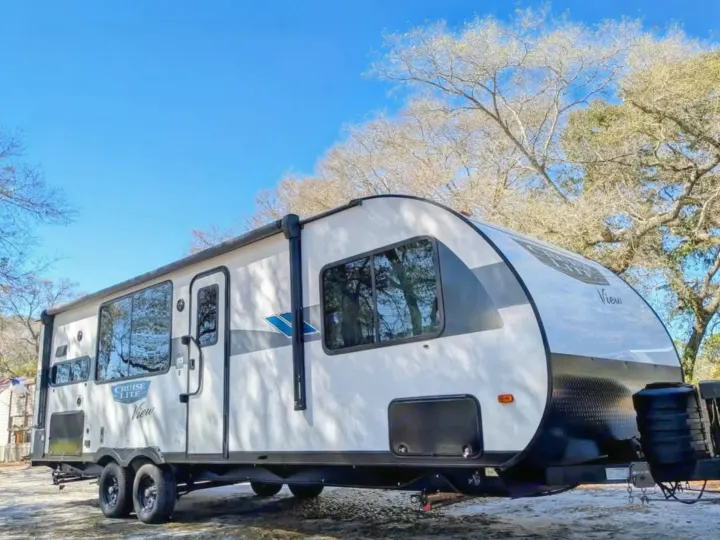 This white and black travel trailer is perfect for your next RV rental adventure, parked under a clear blue sky.. Forest River Salem Cruise Lite 2024