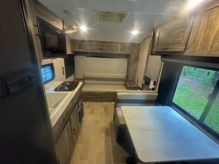 Spacious RV rental interior featuring a modern kitchen, comfortable dinette, and versatile sofa bed.. Forest River Salem 2021