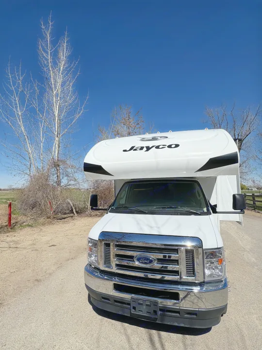 Front view of a white Jayco Class C motorhome on a clear day, ready for your next rv rental adventure.. Jayco Redhawk 2024
