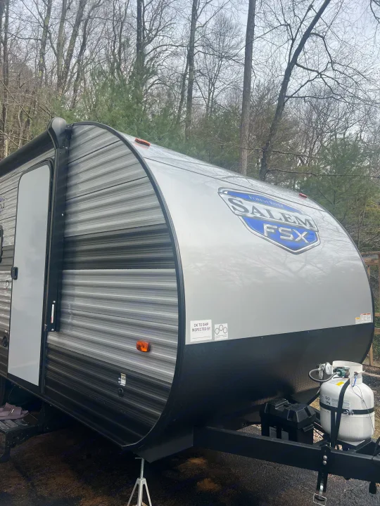 Gray Salem FSX travel trailer, a great option for an rv rental, with propane tanks on the hitch.. Forest River Salem 2024