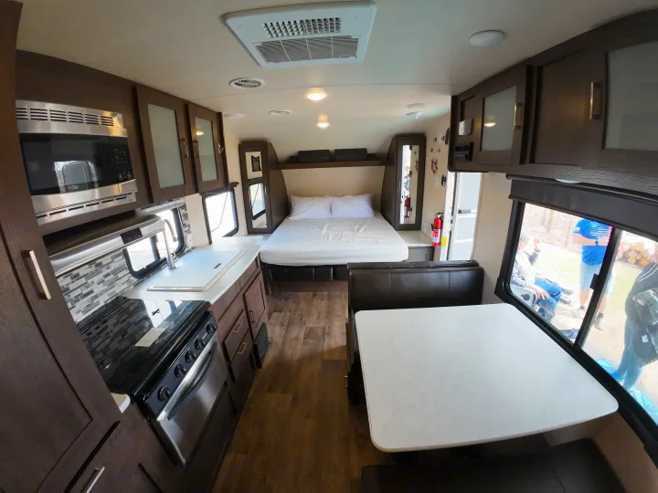 Experience comfort in this RV rental! Features a full kitchen, cozy bedroom, and dinette in a modern travel trailer interior.. Forest River Salem Cruise Lite 2018