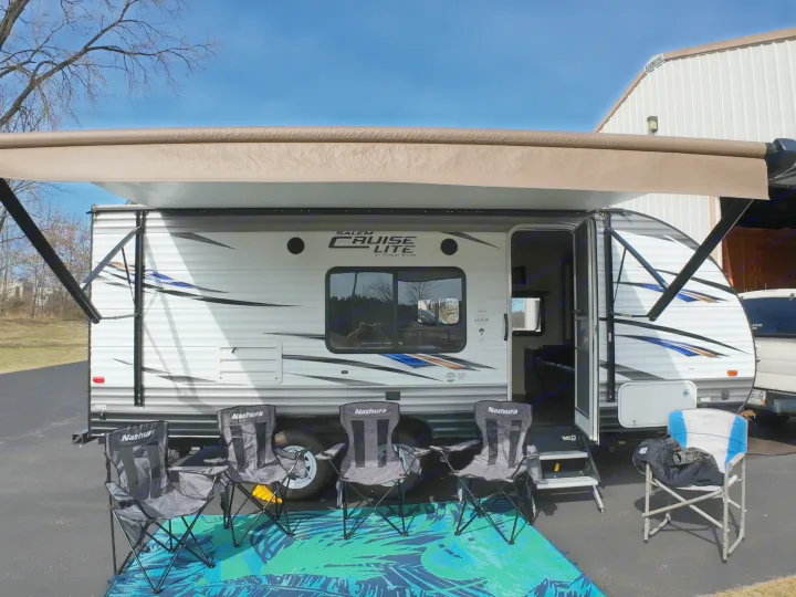 Enjoy this RV rental! A Forest River Salem Cruise Lite travel trailer with awning deployed, plus chairs & mat.. Forest River Salem Cruise Lite 2018