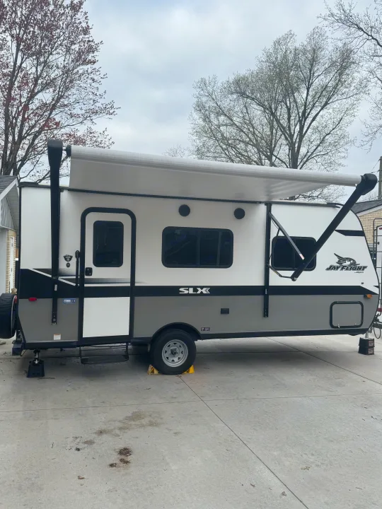 White & gray Jayco Jay Flight SLX RV rental parked with awning extended. Ready for your next adventure.. Jayco Jay Flight SLX 2022