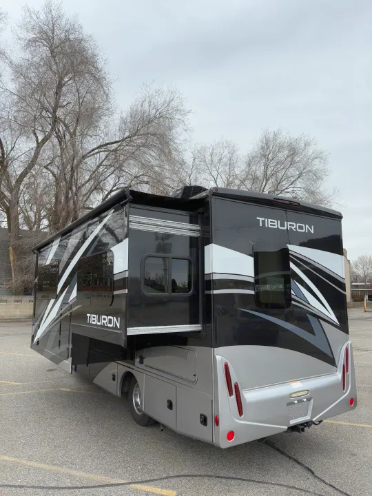 Modern black and silver Tiburon RV rental parked, with slide-outs extended, ready for adventure.. Thor Tiburon 2022