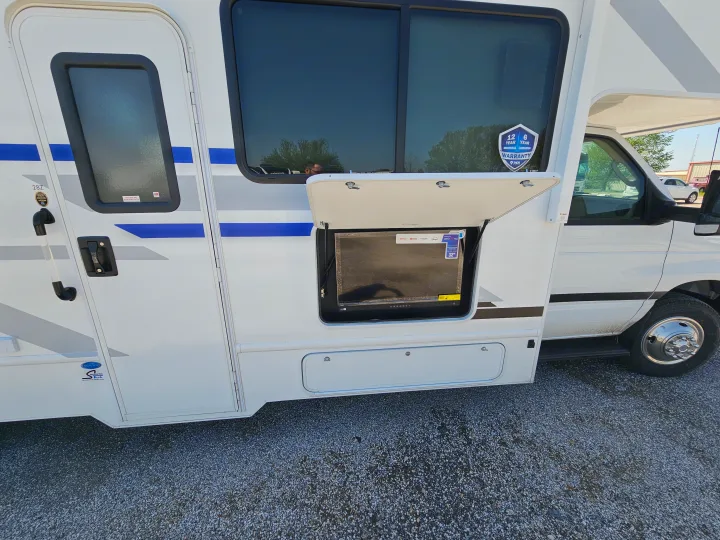 This RV rental offers outdoor entertainment, with an open compartment revealing a 32" smart TV.. Thor Motor Coach Four Winds 2026