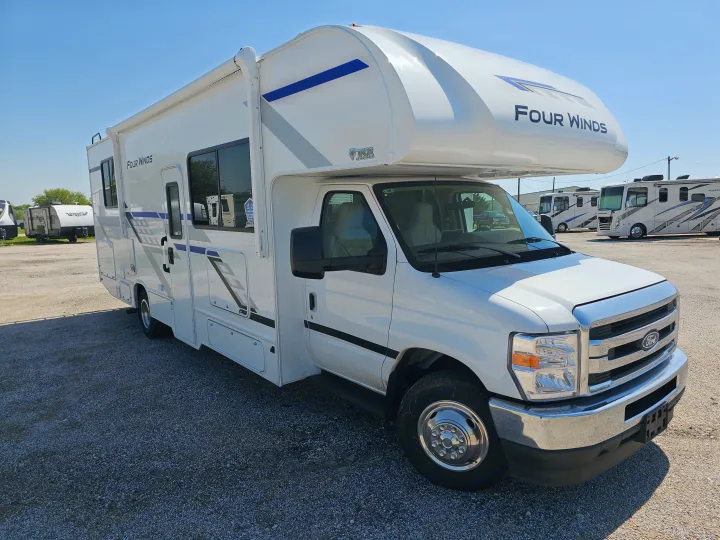 White Four Winds Class C RV rental parked on a gravel lot, ready for your next adventure.. Thor Motor Coach Four Winds 2026