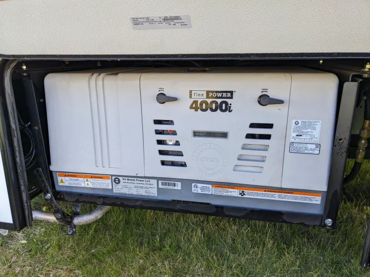 RV rental generator: Flex Power 4000i by RV Mobile Power LLC, installed in a compartment, ready to power your journey.. East to West Alita 2025