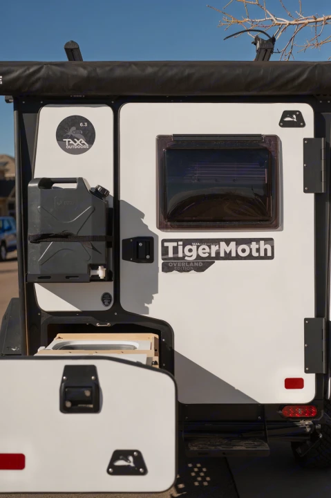 Explore with this Taxa Outdoors TigerMoth Overland Edition RV rental, featuring a mounted jerry can and pull-out kitchen.. TAXA Tiger Moth 2023