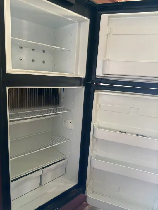 Empty and clean fridge/freezer inside an RV rental, ready for your next adventure's provisions.. Fleetwood Tioga 2011