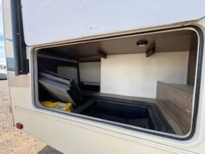 RV rental's spacious pass-through storage bay, open to reveal ample cargo space with bins. Perfect for travel!. Forest River Coachmen Freelander Micro 2018