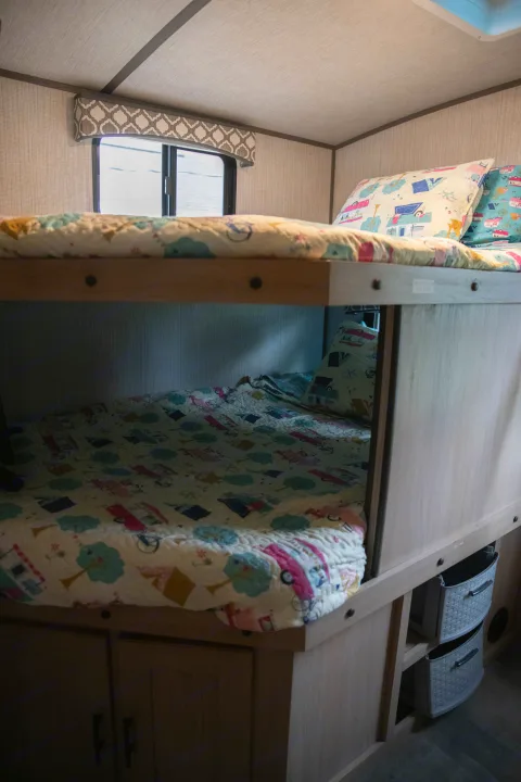 Cozy RV rental bunk beds with fun quilts and storage, ideal for family adventures on the road.. Cruiser RV Radiance Ultra Lite 2020