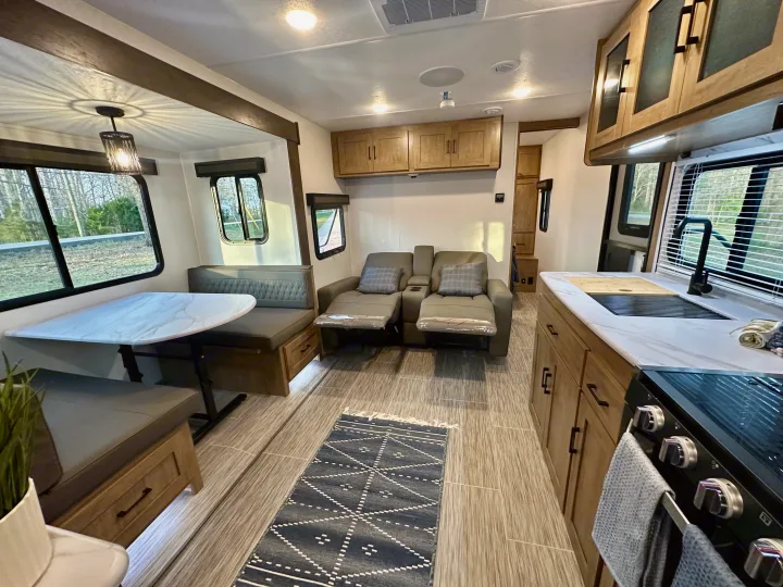 Step inside this modern RV rental! Features a well-equipped kitchen, dining booth, and cozy reclining theater seats.. Forest River Coachmen Freedom Express 2025