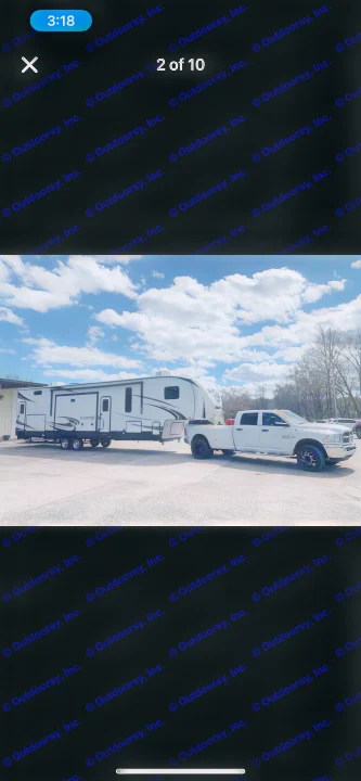 White dually pickup truck hitched to a large white Sabre fifth-wheel RV. Ideal for rv rental travel.. Forest River Sabre 2022