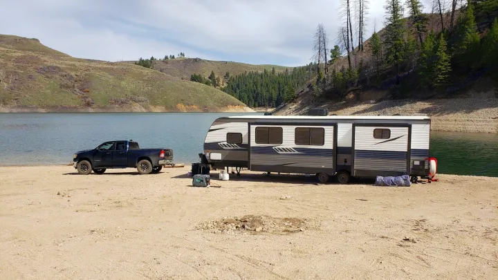 "RV rental" and truck set up for scenic lakeside boondocking, offering a serene outdoor escape.. Crossroads RV Zinger 2020