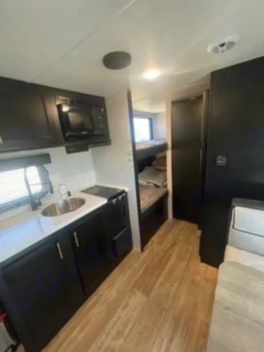 Step inside this RV rental: a modern kitchen, bunk beds, and smart layout offer comfort for your travels.. Forest River Cherokee Wolf Pup 2023