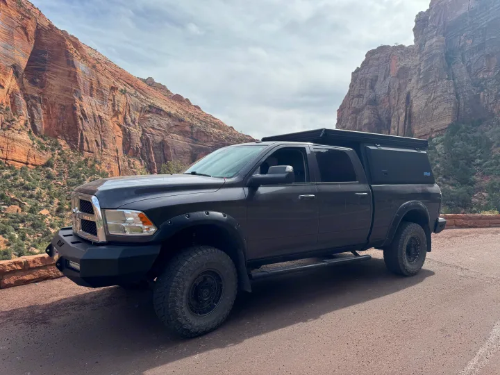 RV rental: An off-road modified pickup truck with a bed camper, parked amidst stunning red rock formations.. Dodge Dodge 1 Ton Pu 2018