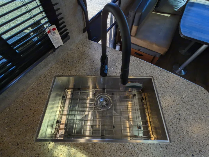 Well-appointed RV rental interior: large kitchen sink, durable countertop, and inviting dinette.. Outdoors RV Timber Ridge 2022