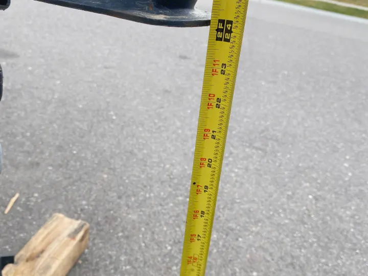 Measuring an RV rental's ground clearance. A tape measure shows the vehicle's underside is approximately 24 inches (2 feet) from the ground.. Jayco Jay Flight SLX Baja Edition 2020