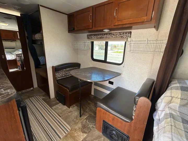 Step inside this inviting RV rental: a spacious dinette area with comfortable benches, a table, and overhead storage.. Jayco Jay Flight SLX Baja Edition 2017