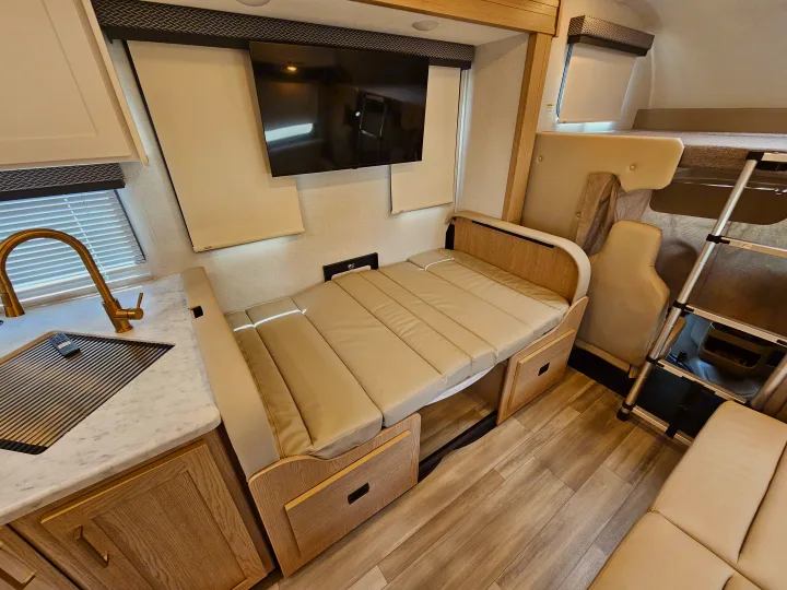 Explore this stylish rv rental with a functional kitchenette, convertible seating/bed, and overhead bunk for comfortable travel.. Thor Motor Coach Four Winds 2026