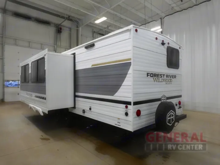 Spacious Forest River Wildwood travel trailer with slide-out, ideal for RV rental adventures. Seen indoors.. Forest River 26Ice 2025