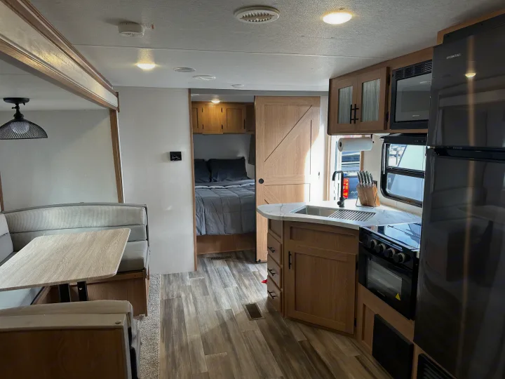 Spacious RV rental interior featuring a full kitchen, dinette, and bedroom, offering comfort for your travels.. Fmc Primetime 2022