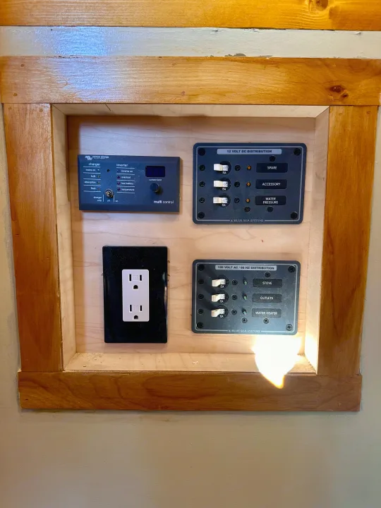 RV rental's power hub: Victron inverter/charger, 12V DC, 120V AC distribution panels, and an outlet for onboard electricity.. Mercedes-Benz Sprinter 2022