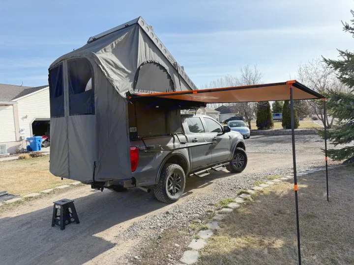 Explore with ease! A grey pickup truck featuring a spacious rooftop tent & awning for ultimate truck camping. Better than RV rental!. Ford Ranger 2300 Cc 2022