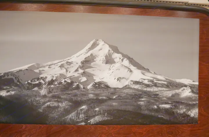 A serene black and white print showcases a snow-capped mountain above dark forests, inspiring RV rental trips.. Ram promaster 2500 2017