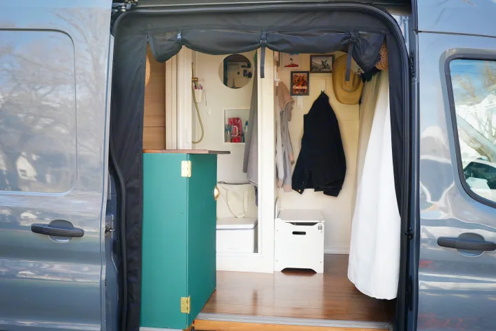Custom RV rental camper van interior, showcasing a shower, storage, and cozy living space.. Ford Transit Custom 2022