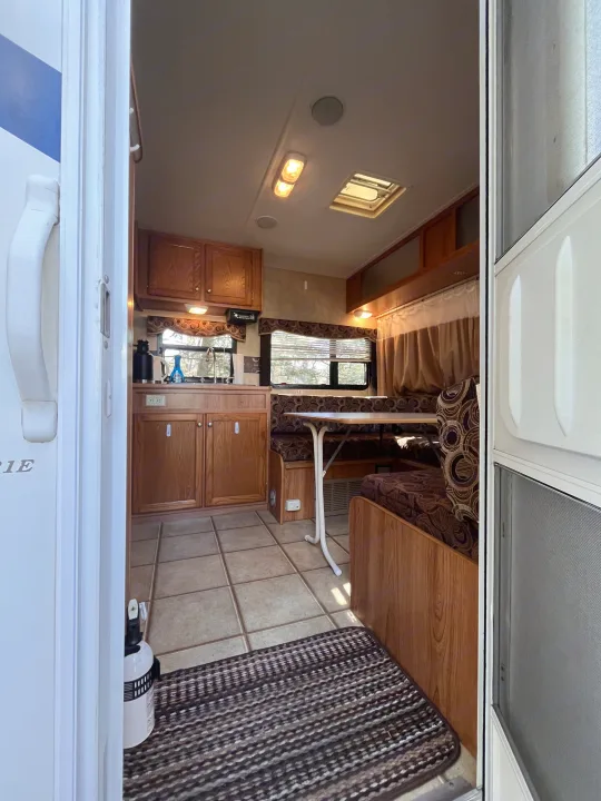 Step inside this RV rental: a compact interior featuring a functional kitchen, cozy dinette, and comfortable living space.. R-Vision Trail Sport 2014